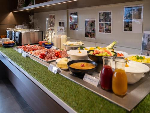a buffet line with many different types of food at Novotel Nantes Centre Gare in Nantes