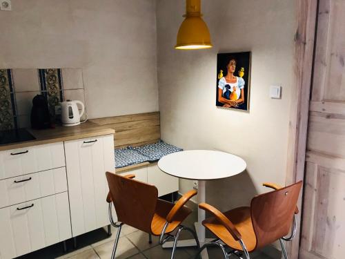 a small kitchen with a table and chairs at Żeromskiego 1 in Warsaw