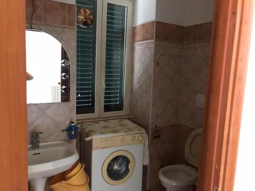 a bathroom with a washing machine and a sink at Palazzo storico in Amaseno