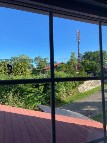a view from a window of a road at Urabandai Cranes in Kitashiobara