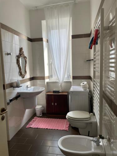 a bathroom with a white toilet and a sink at Casa al Mare Pescara in Pescara