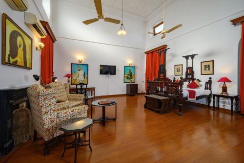 a living room with a couch and a bed at Neemrana's - Baradari Palace in Patiāla