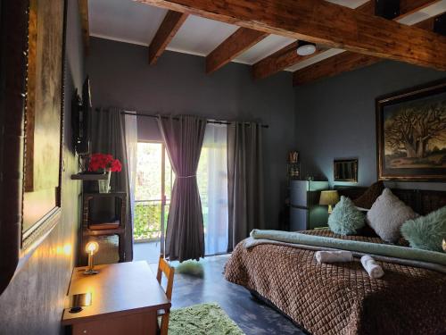 a bedroom with a bed and a table and a window at Suikerbosrant Sleep and go in Pretoria