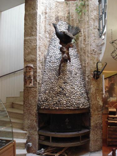 a bird is standing on a bird in a fountain at Hotel Ristorante da Righetto in Campagnano di Roma