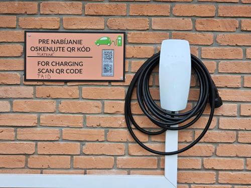 a hose is hooked up to a brick wall at Penzion Pod zámkom-Boleráz in Boleráz