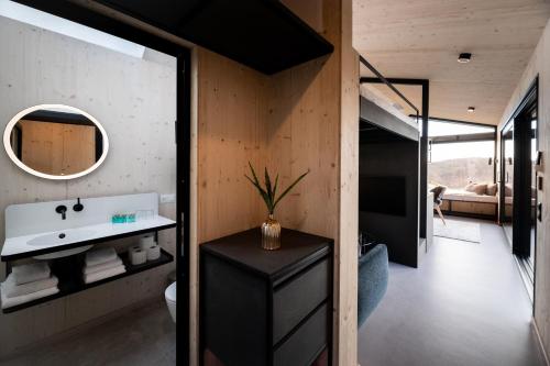a bathroom with a sink and a mirror at Maiers Kuschelhotel Loipersdorf - ADULTS ONLY in Loipersdorf bei Fürstenfeld