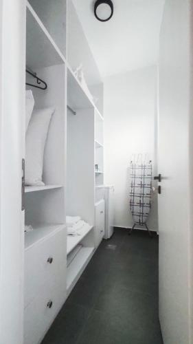 a room with white walls and a room with a closet at Ionis Seafront Suite in Preveza