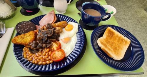 a table with two plates of breakfast food and a cup of coffee at The Mercury, Blackpool - over 21's only in Blackpool