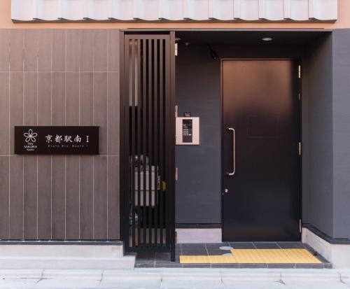 a black door on the side of a building at Stay SAKURA Kyoto Station South I in Kyoto