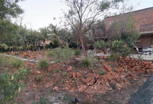 a rock garden in front of a building at Suikerbosrant Sleep and go in Pretoria