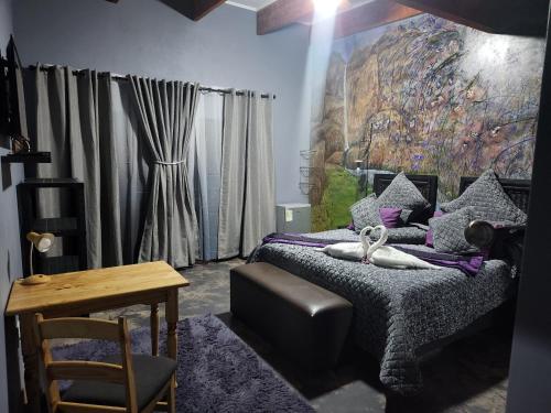 a bedroom with a bed and a painting on the wall at Suikerbosrant Sleep and go in Pretoria