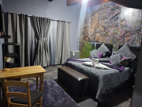 a bedroom with a bed with a painting on the wall at Suikerbosrant Sleep and go in Pretoria