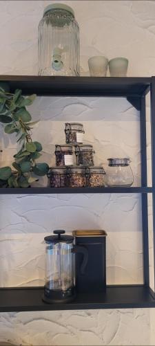 a shelf with a blender and other items on it at Sea-renity 23 met sauna en jacuzzi in Eggewaartskapelle