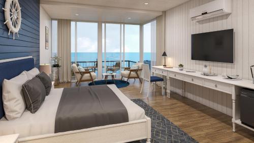 a hotel room with a bed and a desk with a television at Praveg Beach Resort Diu, Chakratirth Beach in Diu