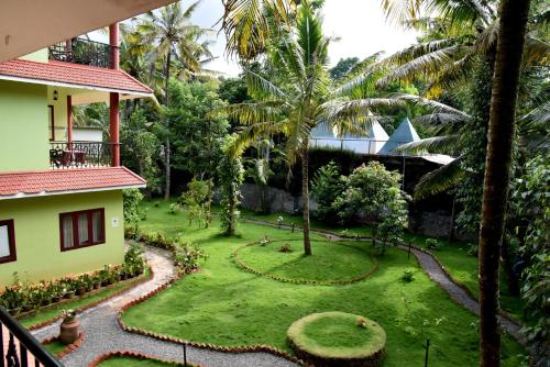a view of a garden from the balcony of a house at Green View in Thekkady
