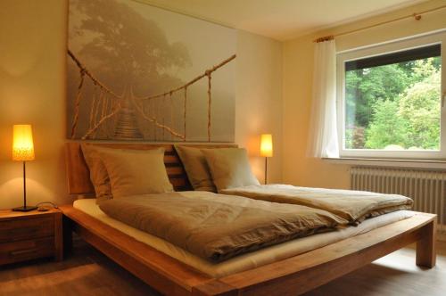 a bedroom with a bed with a bridge painting on the wall at Ferienwohnung Amselnest in Lügde