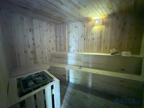 a wooden room with a stove in a room with wood walls at The Elysia Suites in Nusajaya