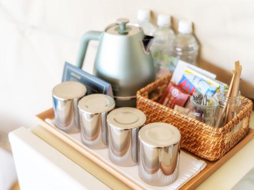a tray with a group of tin cans and a basket at GLAMP ELEMENT(グランエレメント） in Maibara