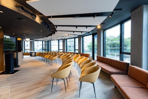 a row of chairs in a room with windows at Crowne Plaza - Marseille Le Dôme in Marseille
