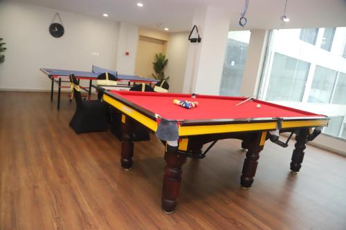 a room with four ping pong tables in it at Mastiff Hotel Ankleshwar in Ankleshwar