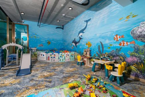 a childrens room with a mural of the ocean at Sala Grand Tuy Hoa Hotel in Tuy Hoa
