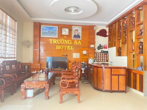 a living room with furniture and a sign on the wall at Trường Sa Hotel Cửa Lò Beach in Cửa Lò