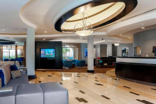 a lobby with a couch and a flat screen tv at Courtyard San Diego Airport/Liberty Station in San Diego