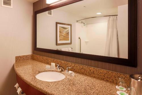 a bathroom with a sink and a large mirror at Courtyard San Diego Airport/Liberty Station in San Diego