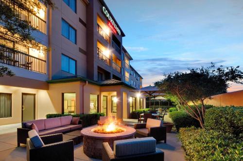 a hotel patio with a fire pit in front of a building at Courtyard Dallas Mesquite in Mesquite