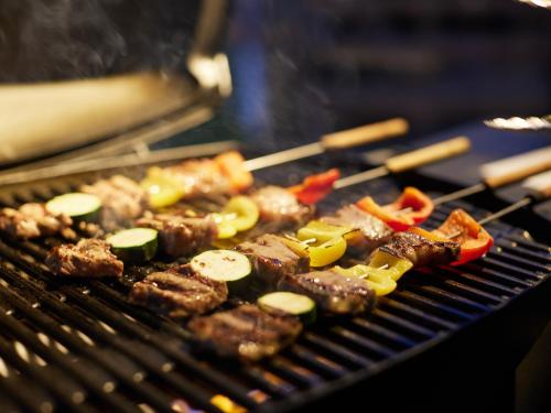 a bunch of meat and vegetables cooking on a grill at GLAMP ELEMENT(グランエレメント） in Maibara