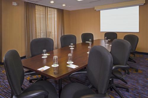a conference room with a wooden table and chairs at Courtyard by Marriott Richmond Northwest in Henrico