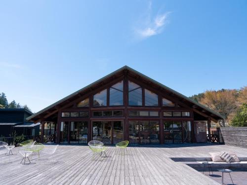 a building with a bunch of chairs in front of it at GLAMP ELEMENT(グランエレメント） in Maibara