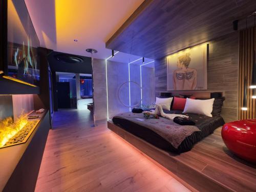 a bedroom with a bed and a fireplace at Les Secrets Rooms - Bonneval - Love Room - Spa et Hammam Privatif in Bonneval