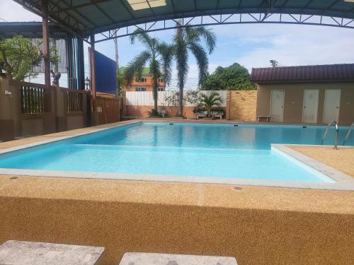 a large swimming pool in a building with a building at EKALUK PLACE INN in North Pattaya