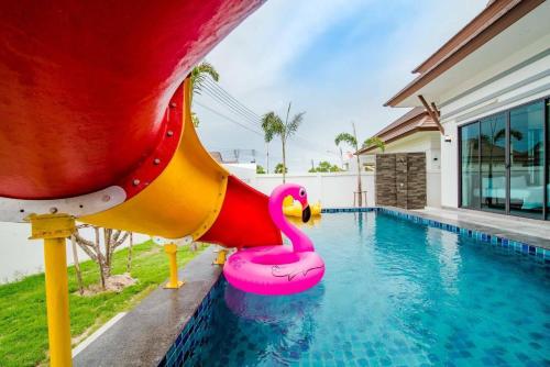 a pool with a pink swan on a slide at Villa Me&you 3 in Ban Bo Fai (1)