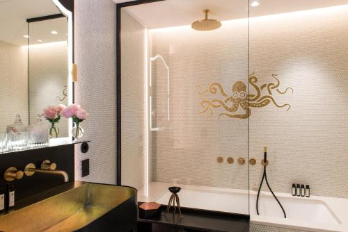 a bathroom with a shower with an octopus on the wall at Nolinski Venezia - Evok Collection in Venice