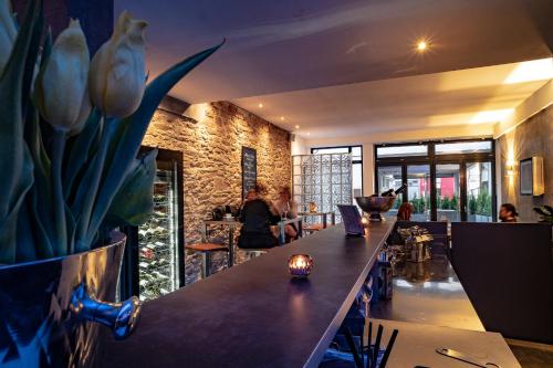 a bar with a long table in a restaurant at ALFA Hotel - Superior in Karlsruhe