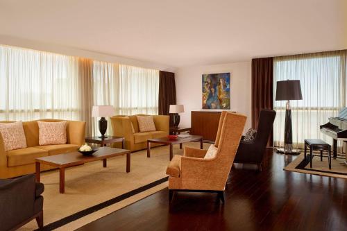 a living room with a couch and chairs and a table at Sheraton Porto Hotel & Spa in Porto