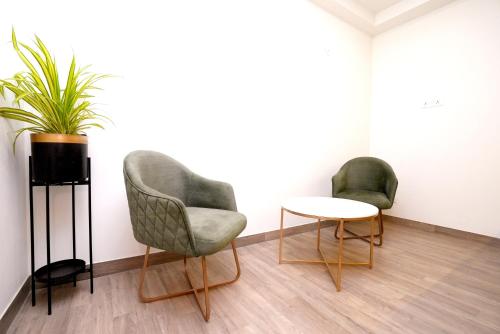 two chairs and a table in a room at Hotel Limon & Banquet Sector 29, Gurgaon in Gurgaon