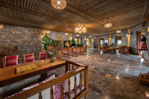 a large room with tables and chairs in a building at Mai Chau Hideaway Lake Resort in Mai Chau