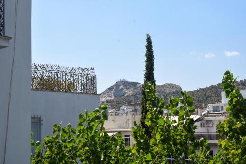 a view of a building with a mountain in the background at Velvet new apt in Ilissia in Athens
