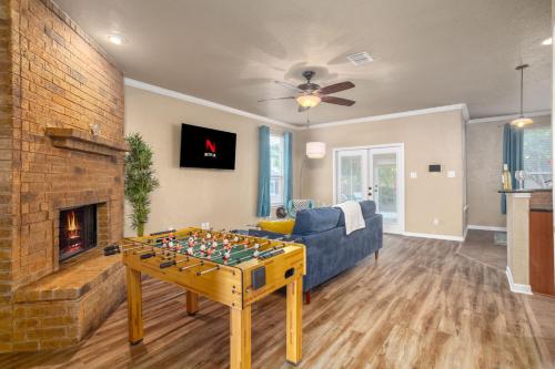 a living room with a chess table and a couch and a fireplace at Cibolo Sa Getaway Wi-fi Bbq Games Parking in Cibolo