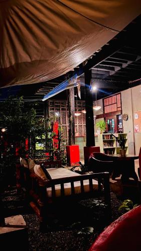 a room with a table and chairs and a tent at Lazy Dog Bed & Breakfast in Boracay