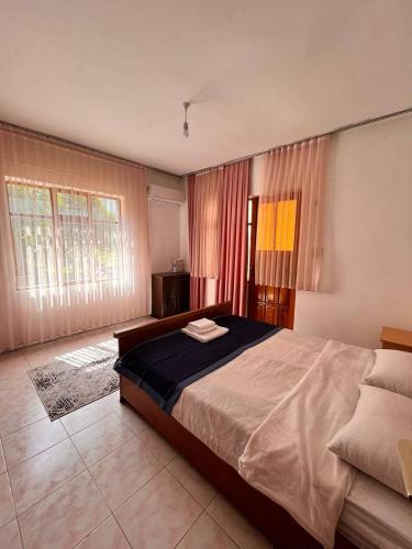 a bedroom with a large bed and a large window at DALAMAN 2 ODALI DAİRE in Dalaman