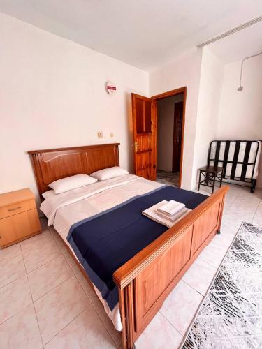 a bedroom with a large wooden bed in a room at DALAMAN 2 ODALI DAİRE in Dalaman