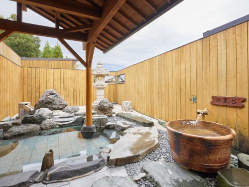 a bathroom with a large copper tub in front of a building at GLAMP ELEMENT(グランエレメント） in Maibara