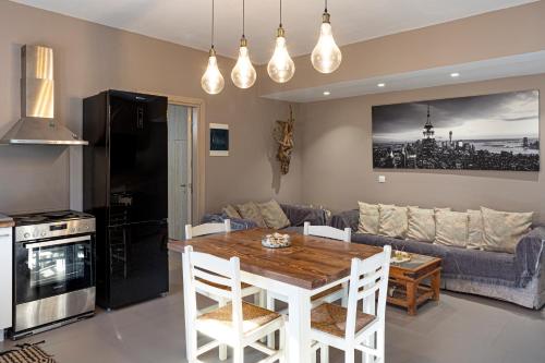 a kitchen and living room with a table and a couch at Irinis Apartments Karfas, Chios in Chios