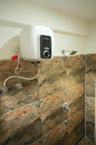 a shower with a blow dryer in a bathroom at 5 STAR GRAND- PREMIUM in Shamshabad