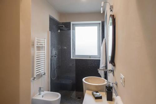 a bathroom with a sink and a toilet and a window at Wp Relais apartments in Diso