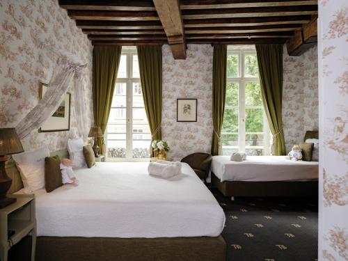 a bedroom with two beds and two windows at Hotel Ter Brughe by CW Hotel Collection in Bruges